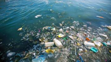 Pollution is visible in a water body filled with plastic waste and debris near a shoreline on a sunny day photo