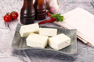 A plate of cheese and tomatoes on a table photo