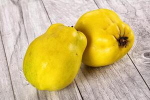 Two yellow fruits on a table photo