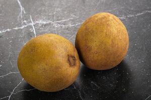 Two ripe kiwis on a table photo