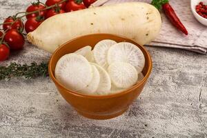 A bowl of white potatoes and vegetables on a table photo