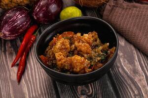 A bowl of food with vegetables and spices photo