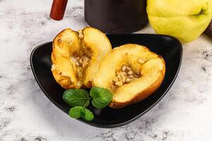 A black plate with two halves of a pear photo