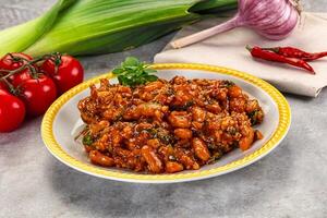 A plate of food with tomatoes and onions photo