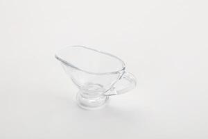 A clear glass pitcher with a handle on a white background photo