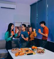 A group of people standing around a table with food photo