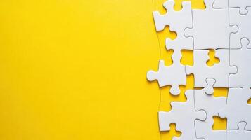 Puzzle pieces on a bright yellow background waiting to be fit together for a creative challenge or relaxing pastime photo
