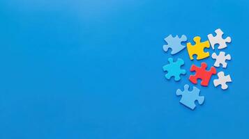 Colorful puzzle pieces scattered on a blue background creating a playful and creative atmosphere for assembly photo