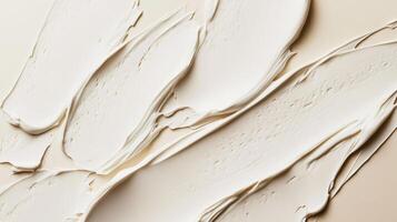 Creamy texture of freshly applied paint on a neutral background showcasing artful brush strokes in warm, soft tones photo