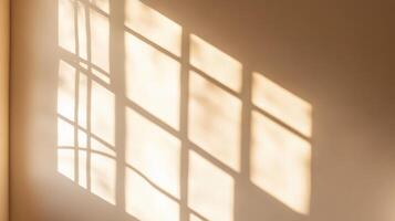 Soft sunlight creates intricate shadows on a beige wall, reflecting the patterns of window frames during early morning hours photo