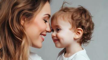 Mother and toddler share a joyful moment during an indoor family gathering in soft lighting, showcasing love and connection between them photo