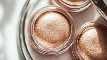 High-quality shimmering eyeshadow products displayed in clear containers capturing natural light during a makeup session at a vanity photo