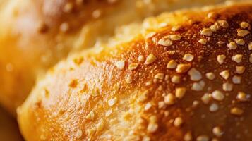 Freshly baked bread rolls topped with sesame seeds on a rustic wooden surface during morning preparation in a bakery photo