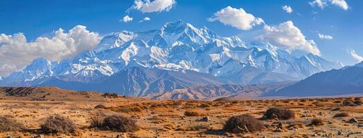 A mountain range with a blue sky and clouds photo