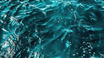 A close up of the ocean waves with some bubbles photo