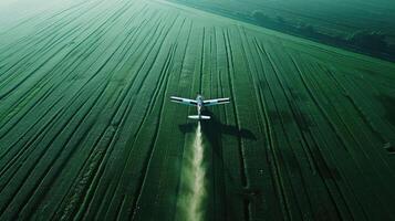 Aerial view of a plane spraying pesticide on a field photo