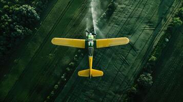 Aerial view of a small airplane spraying water on a field photo
