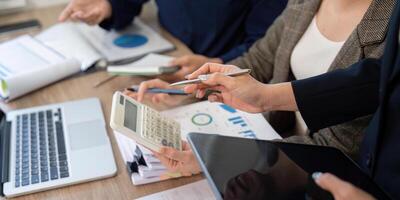 Data Analysis and Financial Reports. Team reviewing documents to strategize tax solutions and business growth. photo