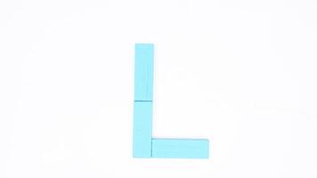 Letter L from blue color wood block isolated on white background photo