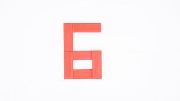 Letter G from red color wood block isolated on white background photo