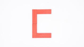 Letter C from red color wood block isolated on white background photo