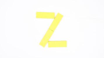 Letter Z from yellow color wood block isolated on white background photo