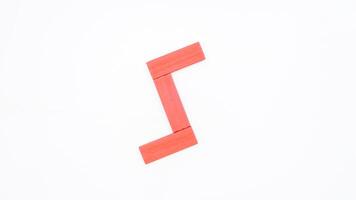 Isolated letter S from red color wood block on white background photo