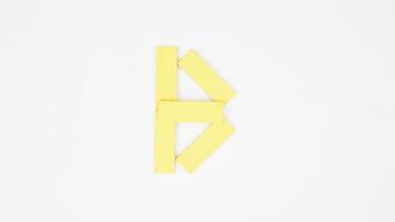 Letter B from yellow color wood block isolated on white background photo