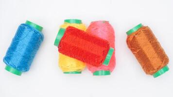 Sewing thread spools with different colors isolated on white background photo