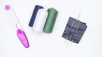 Sewing tools and supplies isolated on white background photo
