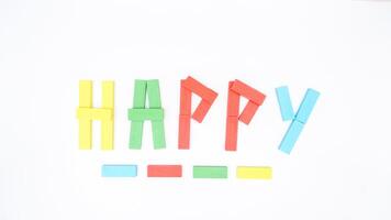 Selective focus of wooden blocks of board game formed word HAPPY isolated on white background photo