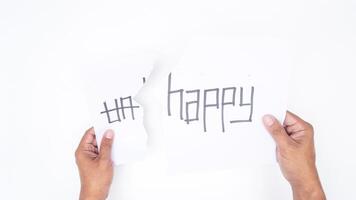 Hands tearing letters UN from word UNHAPPY to get HAPPY isolated on white background photo