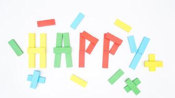 Selective focus of HAPPY word formed using wooden blocks of board game isolated on white background photo