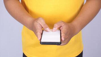 Close up of man holding mobile phone with blank screen mock up isolated on white background photo