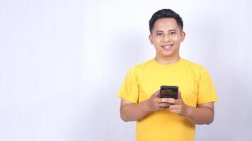 Portrait of Handsome Asian man holding mobile phone isolated on white background photo