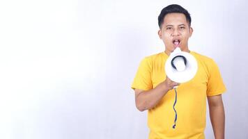Asian young man shouting on megaphone isolated on white background photo