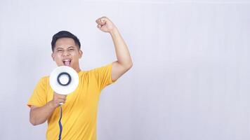 Asian man demonstrate with megaphone isolated on white background photo