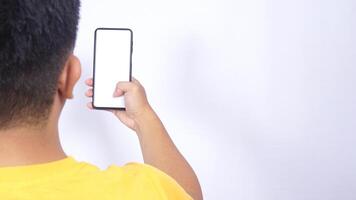 Rear view of man holding mobile phone isolated on white background photo