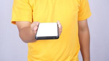 Man hand giving mobile phone mock up blank screen isolated on white background photo