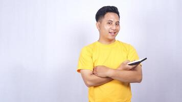 Handsome Asian man playing mobile phone with casual pose isolated on white background photo