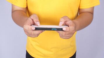Top view of Asian man playing mobile phone in horizontal position isolated on white background photo