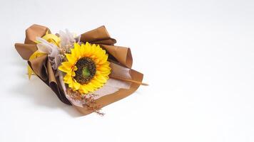 Beautiful fake single sunflower in bouquet made from craft paper isolated on white background photo