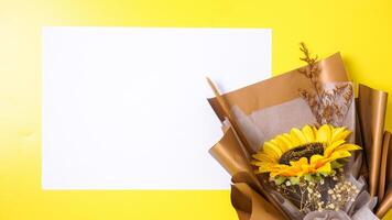 Beautiful artificial or fake single sunflower in bouquet made from craft paper with blank paper for copy space isolated on yellow background photo