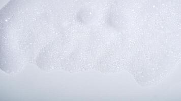 Foam with bubbles isolated on white background photo