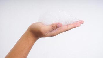 Man hand with white bubbles foam isolated on white background photo