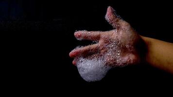 Foam soap with bubble in man hand isolated on black background photo