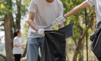 Participants working together to clean up litter in a park, emphasizing teamwork and environmental stewardship. photo