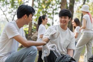 Two young men smiling while participating in a community cleanup event photo