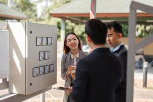 Dynamic sustainable strategy discussion. Diverse professionals collaborating on eco-friendly business practices in an outdoor setting. photo
