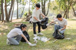 Volunteers sorting and collecting waste during a community cleanup event in the park. photo